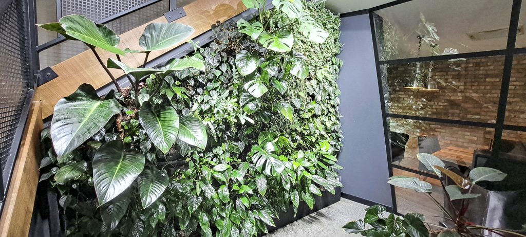 Indoor Fytogreen living wall installed along a stairwell, featuring lush layered foliage and biophilic design elements.